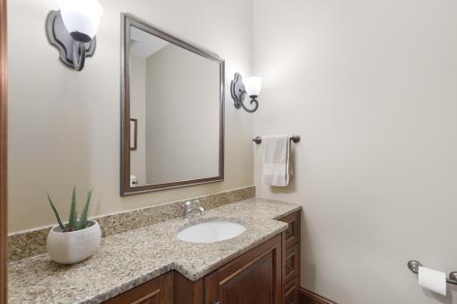 The second of two main-level powder rooms, thoughtfully appointed with a beautiful marble countertop and sophisticated finishes.