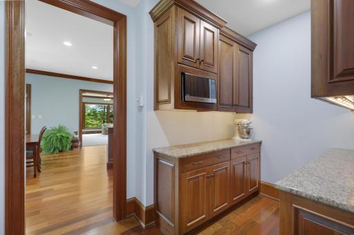 Tucked just beyond the kitchen the butler’s pantry pairs timeless marble countertops with generous workspace.