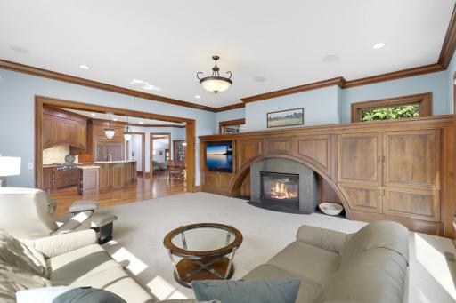 Large windows bring the tranquil beauty of Ferndale Marsh into the living room, while a welcoming fireplace, handsome built-in cabinetry, and thoughtful architectural details create a warm and inviting setting.
