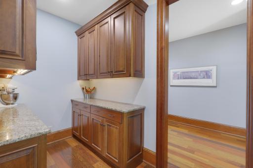 Tucked just beyond the kitchen the butler’s pantry pairs timeless marble countertops with generous workspace.