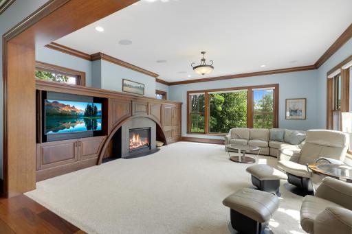 Large windows bring the tranquil beauty of Ferndale Marsh into the living room, while a welcoming fireplace, handsome built-in cabinetry, and thoughtful architectural details create a warm and inviting setting.