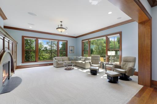 Large windows bring the tranquil beauty of Ferndale Marsh into the living room, while a welcoming fireplace, handsome built-in cabinetry, and thoughtful architectural details create a warm and inviting setting.