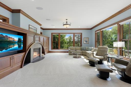 Large windows bring the tranquil beauty of Ferndale Marsh into the living room, while a welcoming fireplace, handsome built-in cabinetry, and thoughtful architectural details create a warm and inviting setting.