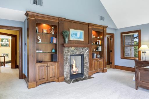 Expansive views and exceptional privacy define the generously sized primary bedroom, where a fireplace adds warmth and character. The luxurious ensuite offers a soaking tub, steam shower, and heated floors.