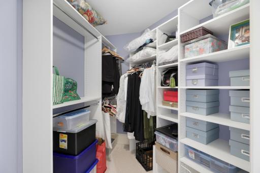 Two private ensuite bedrooms on the upper level feature walk-in closets and picture windows with built-in benches, creating comfortable retreats filled with natural light.