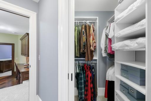 Two private ensuite bedrooms on the upper level feature walk-in closets and picture windows with built-in benches, creating comfortable retreats filled with natural light.