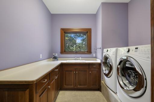A convenient laundry room with utility sink offers a well-designed space for everyday tasks.