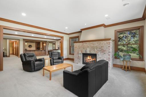 The family room centers around a welcoming fireplace and offers an inviting setting for movie nights and casual gatherings.