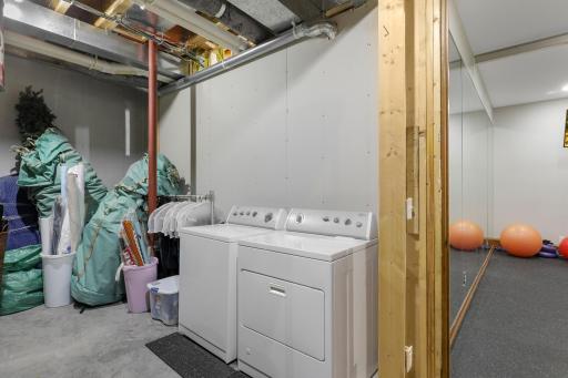 Located off the exercise room, the substantial storage room provides ample organizational space and houses a dedicated washer and dryer.