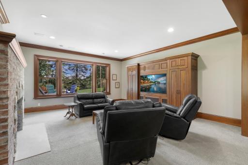 The family room centers around a welcoming fireplace and offers an inviting setting for movie nights and casual gatherings.