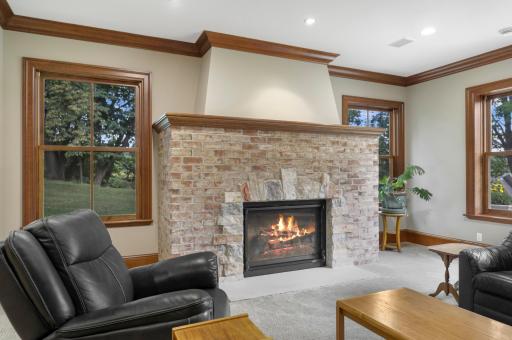 The family room centers around a welcoming fireplace and offers an inviting setting for movie nights and casual gatherings.