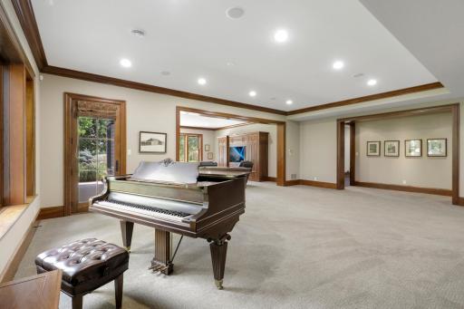 The walk-out lower level offers a spacious recreation room that flows seamlessly into a welcoming family room, anchored by a fireplace.