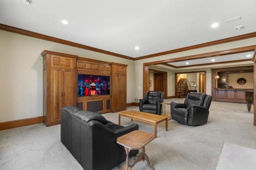 The family room centers around a welcoming fireplace and offers an inviting setting for movie nights and casual gatherings.