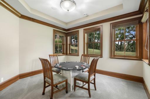 Just off the full wet bar, a dedicated game room creates an inviting setting for cards, games, and relaxed gatherings.