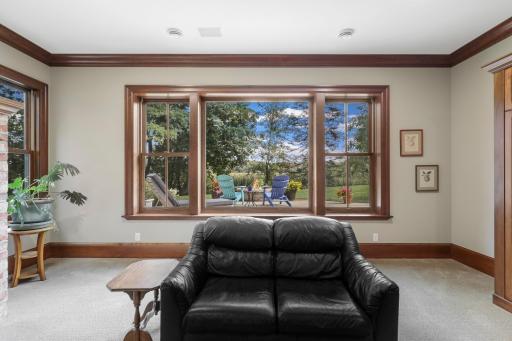 The family room centers around a welcoming fireplace and offers an inviting setting for movie nights and casual gatherings.