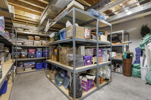 Located off the exercise room, the substantial storage room provides ample organizational space and houses a dedicated washer and dryer.