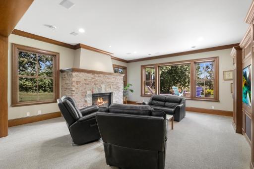 The family room centers around a welcoming fireplace and offers an inviting setting for movie nights and casual gatherings.