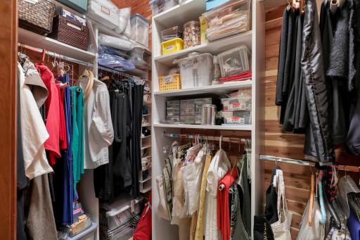 The lower-level fourth bedroom features a cedar closet and is currently appointed as a charming sewing room, offering flexibility for a variety of uses.