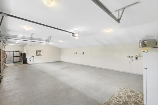 A heated and insulated four-car garage is finished with durable epoxy flooring for year-round use.