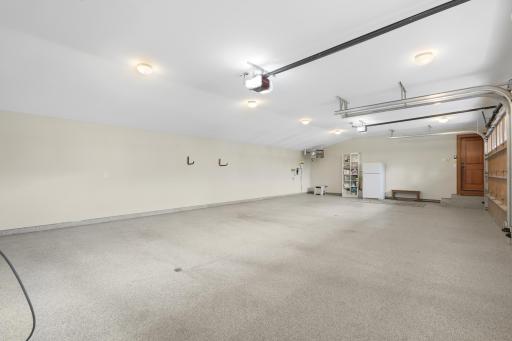 A heated and insulated four-car garage is finished with durable epoxy flooring for year-round use.