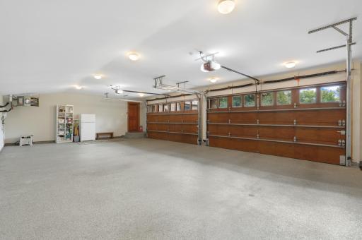 A heated and insulated four-car garage is finished with durable epoxy flooring for year-round use.