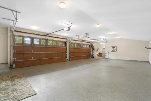 A heated and insulated four-car garage is finished with durable epoxy flooring for year-round use.