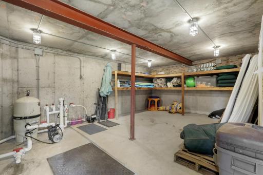 Dedicated storage within the pool room keeps pool equipment and outdoor essentials neatly organized.