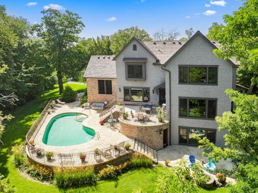 The private backyard oasis centers around an in-ground pool, with multiple terraces creating inviting spaces for lounging and entertaining.