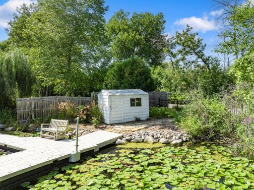 The fenced and gated dock area offers easy access and practical amenities, including a storage shed and room for a golf cart.