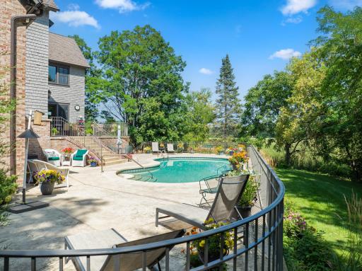 The private backyard oasis centers around an in-ground pool, with multiple terraces creating inviting spaces for lounging and entertaining.