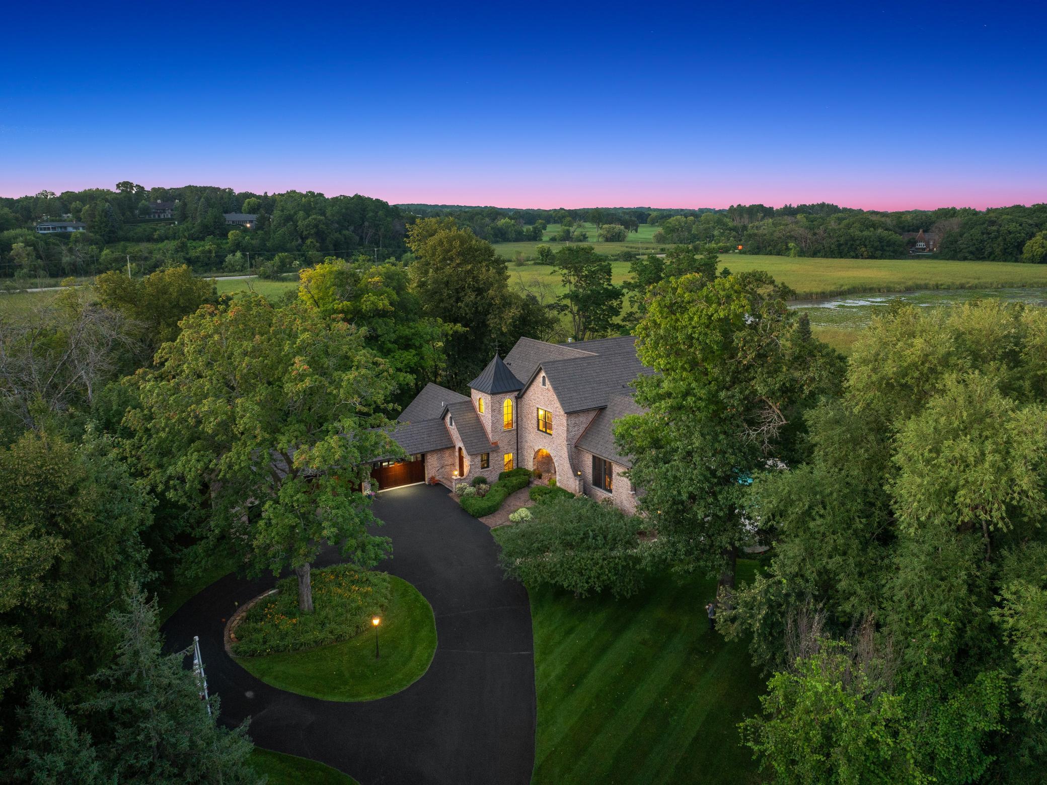 Located on one of Minnesota's most distinguished streets, this 2005 Jyland is tucked beautifully into its 3+ acre, resort-like setting, with 360 degrees of wooded privacy, expansive wetland views.