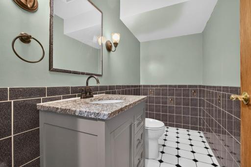 A tiled half bathroom with newer vanity is adjacent to the garage and gathering rooms. Need a tub? Shower? It has plenty of room for future installation.