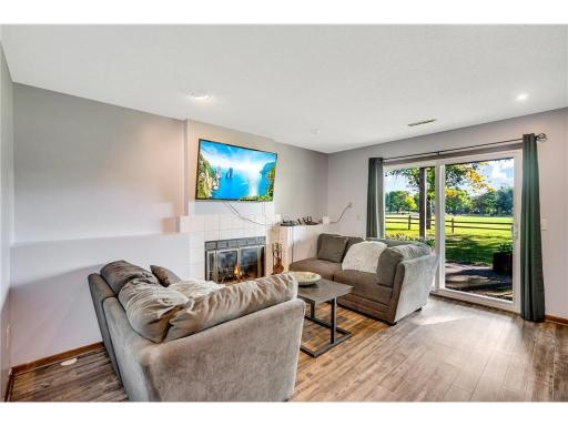 The lower-level showcases update flooring, fireplace, walkout, and flex/rec area.