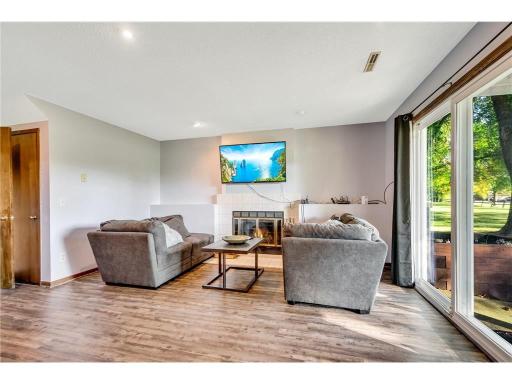 Natural light-filled and comfortable room that accommodates another gathering area. The walkout is a hit with letting Fido out!