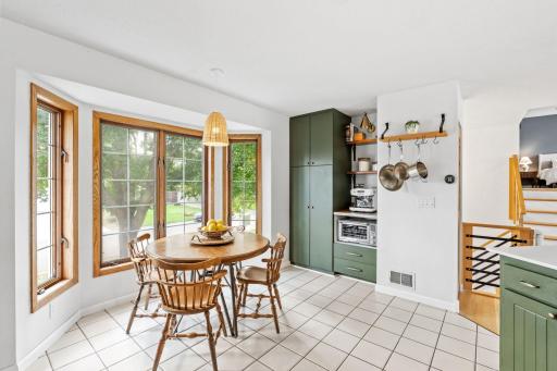 The informal eat-in kitchen sets next to bay windows, with great lighting and views of the front yard.