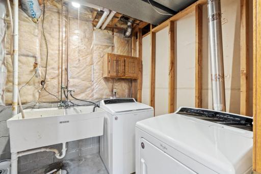Laundry and utility area with washer, dryer, and a utility sink.