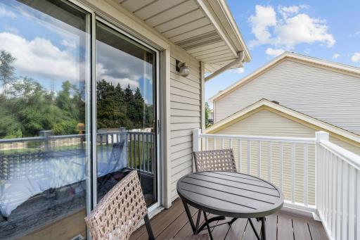 Primary bedroom balcony with sliding glass door access and space for a bistro set.