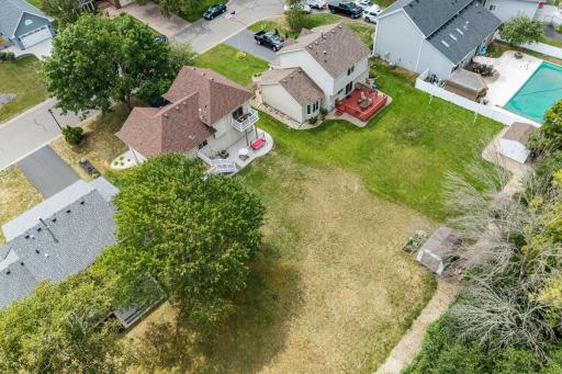Aerial view of the neighborhood showing surrounding lots and mature trees.