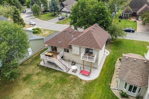 Aerial view of the rear of the home with the deck and backyard. Landscaping updated in 2021.