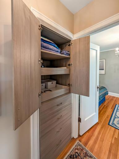Sleek storage for linens and other items just outside the bedroom door!
