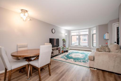 Shared dining/living space. Unit has beautiful luxury vinyl tile flooring throughout.