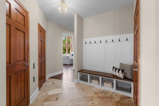 Main level mudroom with access to the mother-in-law suite, garage, elevator and front patio complete with tile floors.