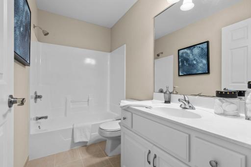 Full bathroom ensuite located within the second bedroom on the upper level.