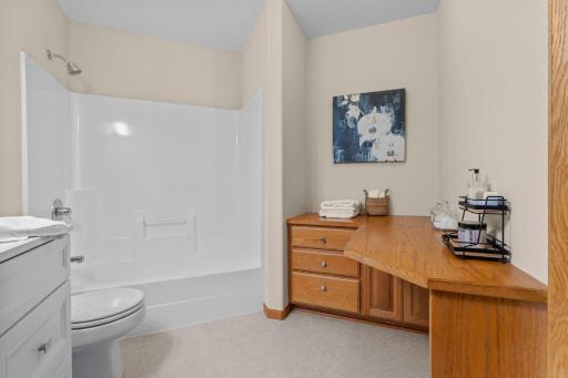 Full bathroom in the mother-in-law suite complete with a tub and shower and built in vanity area.