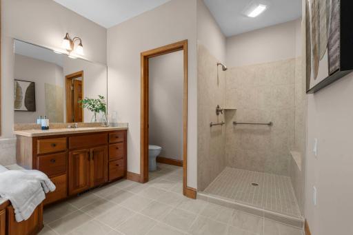A walk in shower and dual vanities.