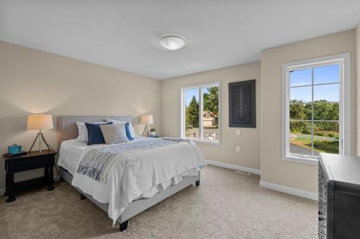 Third bedroom on the upper level flooded with natural light from the front yard views.
