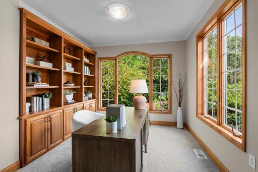 Main level office/den that could be used as a flex space or library complete with built-ins for storage.