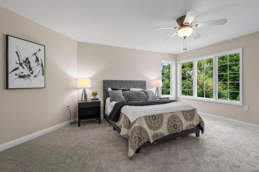 Second bedroom on the upper level overlooking the side yard.