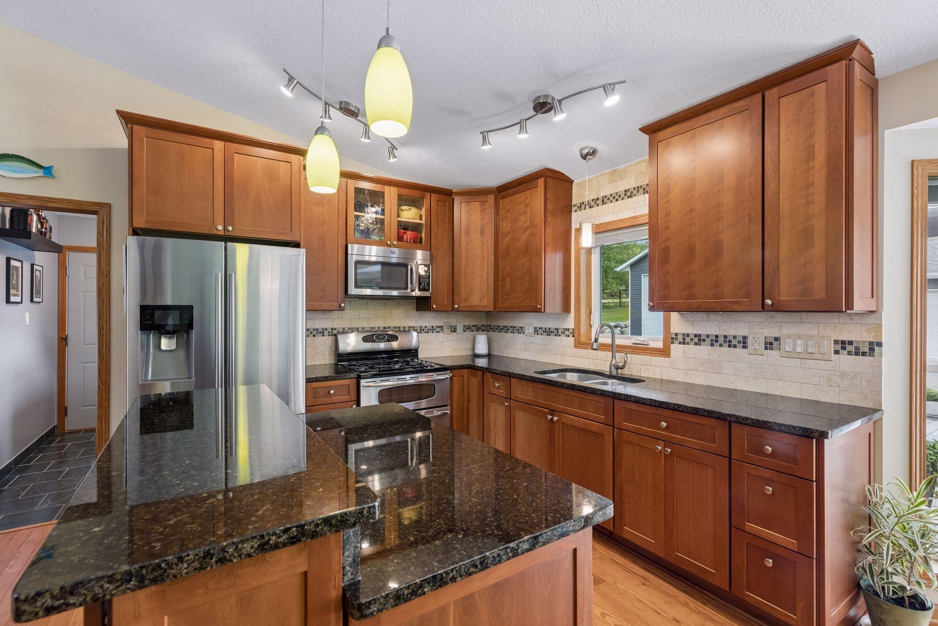 Thoughtfully designed for everyday function, the kitchen showcases beautiful cabinetry, granite countertops, tile backsplash, stainless steel appliances, a double sink, and generous prep space.