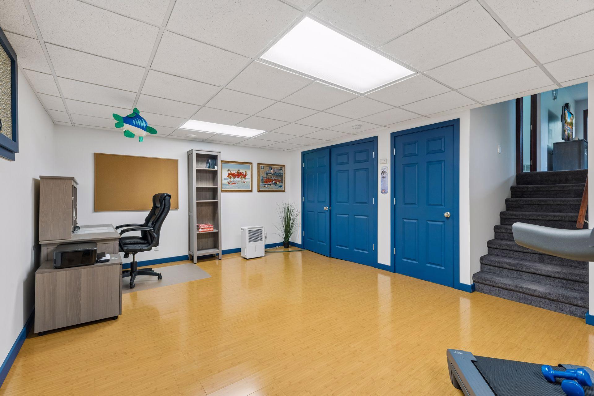 The wide stairway provides a natural transition between levels, leading to the family room, additional bedroom, and bathroom.